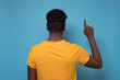 © Viktor Koldunov - Back view of pointing up blackman. gesticulating showing on copyspace.