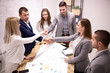 © Nikola Spasenoski - group of young people in modern workplace, having a creative meeting, shaking hands