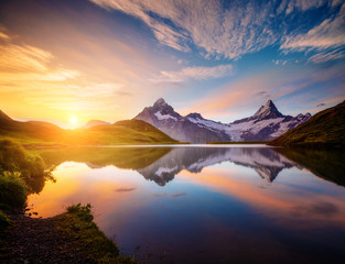 Wall Mural - Magnificent panorama of the alpine lake Bachalpsee at dawn. Location Swiss alps, resort Grindelwald,