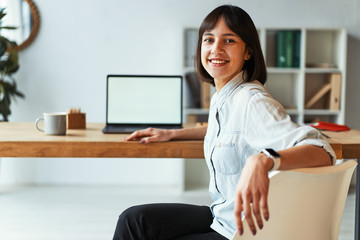 Wall Mural - Beautiful girl smiling at camera in office