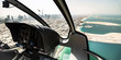 cockpit of helicopter, aerial view over coast of Dubai and Downtown skyline