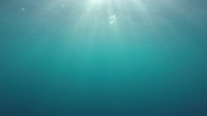 sunbeams in clear blue ocean underwater video