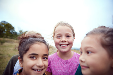 Portrait Of Children On Outdoor Activity Camping Trip Having Fun Playing Game Together