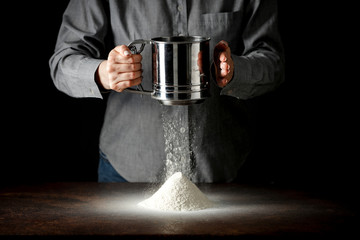 Sticker - hands with flour working in the kitchen on the wooden table splash