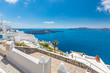 Beautiful terrace in Santorini with breathtaking view. Luxury vacation and summer travel background. Urban, street details. Amazing blue sky and white architecture