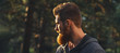 © USM Photography - Close up portrait of confident bearded man in a autumn park. Profile young handsome serious bearded man Young hipster hiking forest.