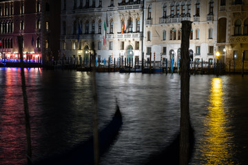 Wall Mural - Venice canal with historical buildings and gondolas at night. Italy.