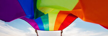 Gay Rainbow Flag On A Green Meadow Outdoors