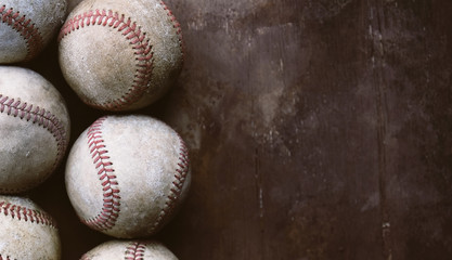 Old baseballs on vintage background as sports border.