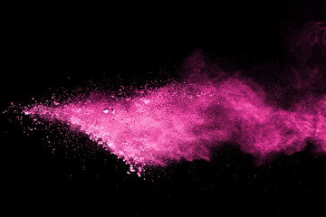 Wall Mural - pink powder explosion on black background. colored cloud. colorful dust explode. paint holi.