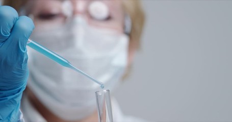 Wall Mural - technician carefully drips the solution from the pipette into glass tubes for dna analysis.