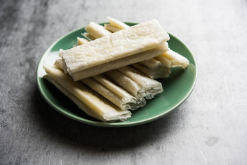 Wall Mural - Pootharekulu  is a popular recipe originated from Andhra Pradesh, India.It is a paper-thin sweet or dessert made from rice start/gram flour, jaggery/sugar and clarified butter. Served in a plate.