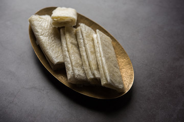 Sticker - Pootharekulu  is a popular recipe originated from Andhra Pradesh, India.It is a paper-thin sweet or dessert made from rice start/gram flour, jaggery/sugar and clarified butter. Served in a plate.