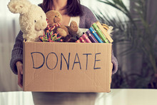 Donation Box With Children Toys. Woman Collects Toys For Charity.