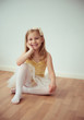 © spass - Cute little blonde girl sitting in ballet tutu
