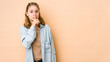 © Asier - Young caucasian woman isolated on beige background keeping a secret or asking for silence.