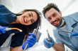 © Тарас Нагирняк - Portrait of a young female nurse and dentist doctor wearing a blue coat posing in a dentist office with medical equipment.