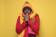 © Viktor Koldunov - man in several hats and scarfs on yellow background.