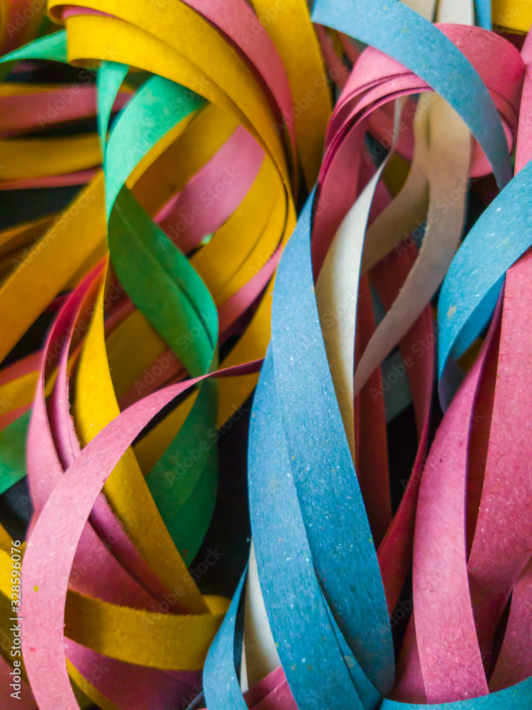 Very colorful Brazilian carnival streamers, are made of recycled paper and last for only one party. - obrazy, fototapety, plakaty 