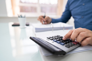 businessman calculating invoice