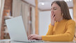 © stockbakers - Sleepy Young Woman Yawning in Office