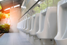 Close Up Row Of Outdoor White Urinals Men In Public Toilet.