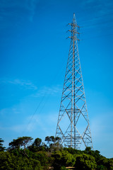 a high electric pole and transmission line on an island