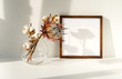 © irenastar - photo frame mock up, dry exotic flowers in a vase on the table and shadows. interious design. copy space