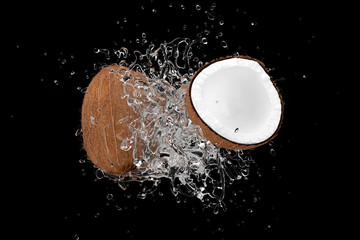 Wall Mural - explosion coconut juice with coconut fruit on black background. 3d render.