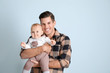 © Pixel-Shot - Cute baby with father on light background