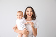 © Pixel-Shot - Cute baby with mother on light background