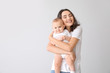 © Pixel-Shot - Cute baby with mother on light background