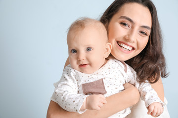 Canvas Print - Cute baby with mother on light background