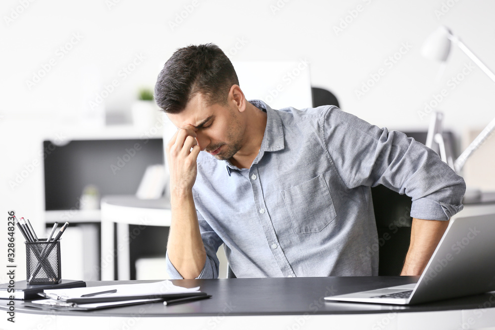 Depressed young businessman in office