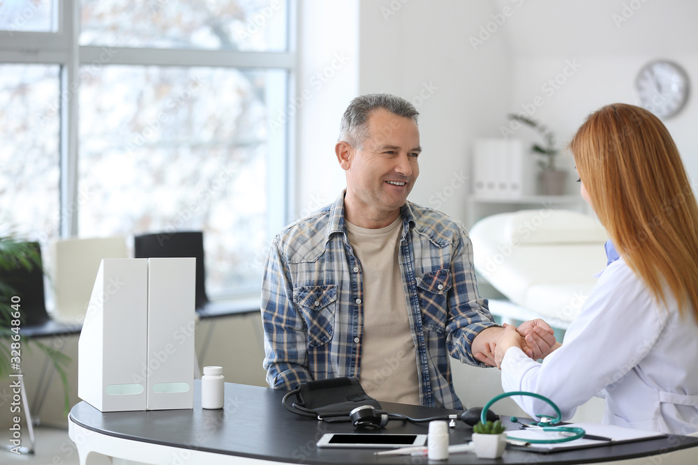 Mature man visiting doctor in clinic
