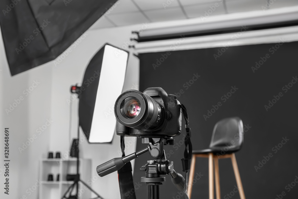 Modern camera in professional photo studio