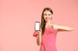 © Pixel-Shot - Young woman with mobile phone on color background