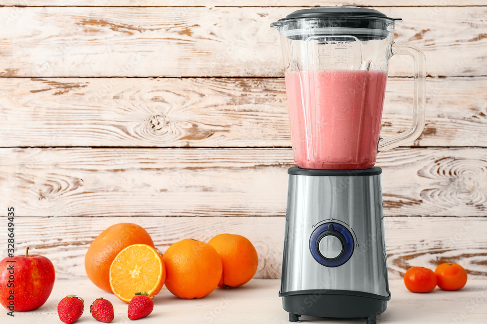 Blender with ingredients for healthy smoothie on table