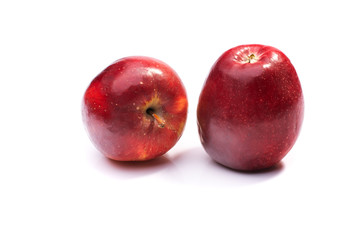 two red ripe apples close up on a white isolated background