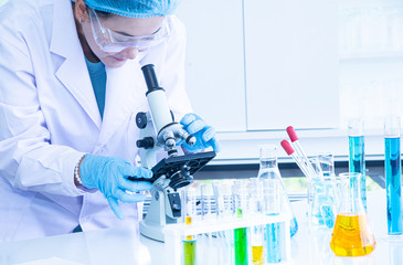 Wall Mural - Asian woman scientist, researcher, technician, or student conducted research in laboratory