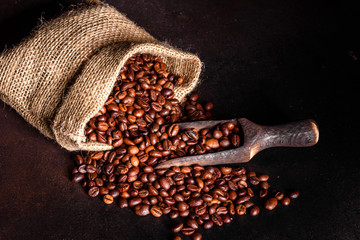 Grains of fresh roasted coffee close-up against a dark background. Coffee beans texture