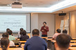 © Pornchai - Asian Speaker is speaking on the stage over the presentation screen in the education seminar