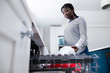 © Daisy Daisy - Teenage Girl Boy Helping With Chores At Home By Stacking Crockery In Dishwasher