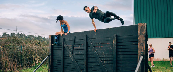 Participants in obstacle course climbing wall