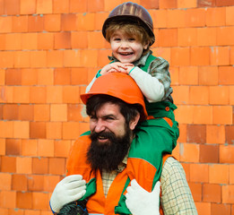 Wall Mural - Happy kids smile. Father and child. Cute son on fathers shoulders. Construction. Father builder.