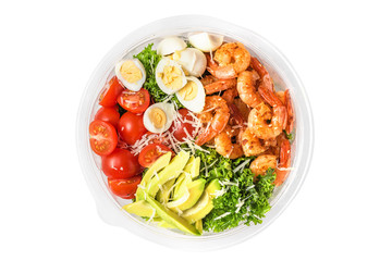 Healthy shrimp caesar salad in plastic package for take away or food delivery isolated on white background. top view