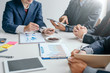 © amnaj - Group of business people discuss together the coffee business at the meeting.