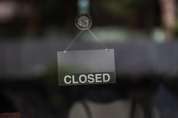 Wall Mural - sorry we are closed sign hanging outside a restaurant, store, office or other