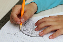 Closeup Child's Hands Measuring Angle By Protractor