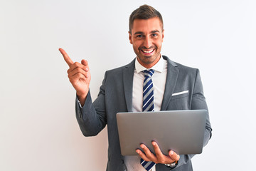 Young handsome business man working using computer laptop over isolated background very happy pointing with hand and finger to the side